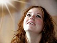lights rays shining on a woman